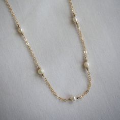 This pearl satellite necklace is the perfect layering piece! Dainty freshwater pearls on a 14K gold-filled chain. Stack with other necklaces or simply wear it alone, this necklace will shine either way!  Necklace length: 14", 16", 18", 20", 22" Extender length (optional): 2" Pearl size: 4mm ➤【 PLEASE READ 】➤ ✿ IMPORTANT ✿ Due to the organic nature of freshwater pearls, each pearl will differ slightly in size and shape and may feature small marks, white lines/spots, and/or dimples. Their beauty lies in their individuality! Please verify all measurements before placing an order. ✿ PROCESSING TIME ✿ Please allow 1-3 business days to handmake your jewelry before shipping out! ✿ WHAT IS GOLD-FILLED? ✿ Gold-filled jewelry is an excellent alternative to solid gold. It is a thick layer of gold tha Gold Pearl Necklace With Satellite Chain In Dainty Style, Pearl Necklace With Satellite Chain As Gift, Delicate Pearl Necklace With Satellite Chain, Pearl Satellite Chain Necklace As Gift, Gold-plated Pearl Necklace With Delicate Chain, Dainty 14k Gold-filled Yellow Gold Pearl Necklace, Dainty 14k Gold-filled Pearl Necklace With Adjustable Chain, Elegant 14k Gold-filled Pearl Necklace, Elegant 14k Gold-filled Pearl Chain Necklace