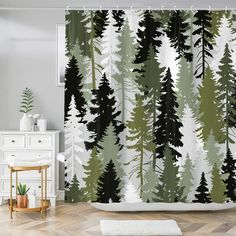 a bathroom with a shower curtain that has trees on it