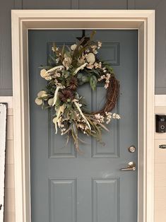 a wreath on the front door of a house