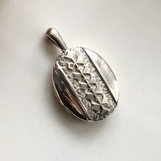 A large antique silver locket pendant. A beautifully decorated piece perfect for displaying an old photograph or two. CONDITION: Good condition, wear consistent with age and use. Good click but pops open after time. Please see photos for more detail. Glass still inside.  LOCKET SIZE: 43mm x 35mm LOCKET LENGTH INC. LOOP: 60mm LOCKET WEIGHT: 14.8 WINDOW SIZE (INSIDE): 40mm x 30mm (8-11-10) Vintage Silver Oval Pendant Locket Necklace, Vintage Silver Medallion Locket Necklace, Collectible Hallmarked Silver Locket Necklace, Vintage Hallmarked Silver Locket Necklace, Silver Vintage Medallion Locket Necklace, Vintage Etched Oval Pendant Locket Necklace, Antique Silver Sterling Silver Vintage Locket Necklace, Antique Silver Sterling Silver Locket Necklace, Antique Silver Locket Necklace With Vintage Charm