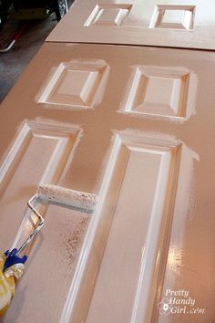 a person painting the inside of a door