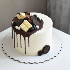 a white cake with chocolate and cookies on top