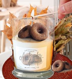 a candle with two doughnuts on top of it