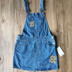 Brand New With Tags! Never Worn! Super Cute Denim Overalls With Golden Embroidered Flower Accents. The Embroidery Add Some Extra Style To The Traditional Overall Dress! Size: Small Embroidered Denim Blue Dress, Embroidered Denim Dress In Blue, Embroidered Blue Denim Dress, Blue Embroidered Denim Dress, Fitted Embroidered Denim Dress, Spring Embroidered Denim Dress, Embroidered Denim Dress For Spring, Casual Denim Blue Dress With Floral Embroidery, Casual Embroidered Medium Wash Denim Dress