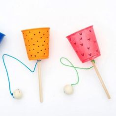 three different types of toothpicks with string attached to them on a white surface