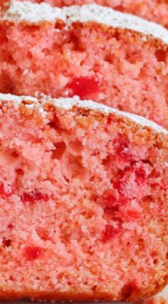 slices of strawberry cake with powdered sugar on top and one slice cut from it