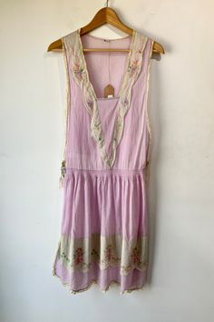 Vintage 1930s Lavender Pinafore Dress. Soft lavender cotton voile apron style dress. Has a scallop and embroidered v-neckline and lace trim details. Ribbon ties at sides for easy on and off. 100% cotton, handwash cold. No marked size, fit is approximate S/M. Approx. Measurements Waist: 16” Length: 41” Summer Lavender Dress With Lace Trim, Summer Lavender Dresses With Lace Trim, Lavender Bohemian Day Dresses, Vintage Lavender Dress For Daywear, 1920s Style Spring Daywear Dresses, 1920s Style Spring Day Dresses, 1920s Style Day Dresses For Spring, Lavender Cotton, Soft Lavender