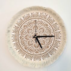 a clock made out of woven material with black hands and numbers on the front side