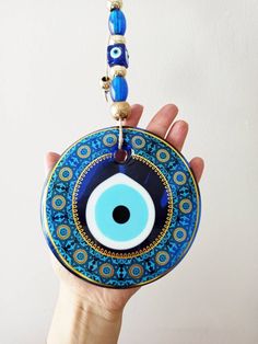 Width of the blue evil eye is 13 cm(5.11 in) Large Round bead is made of glass. Height of the Evil eye wall hanging is 31 cm(12.20 in) This charm is known as mati, Turkish Evil Eye, Turkish Nazar Boncuk and Greek Eye. Evil eye amulet is used as a wall hanging for protection. You can place this large evil eye with rope in your home or office. Evil eye amulet can be a great housewarming gift. For more evil eye hangings, click the link below; https://www.etsy.com/shop/EyeDesignsbyGG?ref=search_shop Handmade Blue Evil Eye Bracelet For Festival, Bohemian Blue Evil Eye Bracelet For Festival, Blue Evil Eye Bracelet For Festivals, Protection Talisman, Evil Eye Wall Hanging, Greek Eye, Turkish Decor, Turkish Eye, Turkish Evil Eye