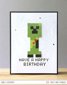 a greeting card with an image of a green zombie holding a red heart and the words have a happy birthday written on it