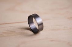 This is a beautiful handcrafted Tantalum Ring with a lightly brushed finish.The ring pictured is 7mm wide, the thickness is approx. 1.7mm.99.95% purity tantalum.Each ring is 100% hand made using traditional jewellery making techniques.The ring is then hand brushed to finish.Tantalum is hypoallergenic so a great ring for those with skin allergies to common metals.Our rings are 100% hand-made to order, please allow for time while crafting your ring. Please contact me for current turnaround times.T Minimalist Titanium Rings For Formal Occasions, Minimalist Rings With Brushed Finish For Gift, Minimalist Rings With Brushed Finish As Gift, Minimalist Titanium Rings For Anniversary, Minimalist Brushed Finish Promise Ring, Grey Wedding Ring, Round Minimalist Titanium Jewelry, Minimalist Round Titanium Jewelry, Mens Tantalum Rings