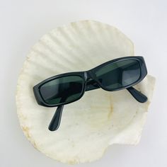 These bold rectangle sunglasses are your everyday go to pair. Featuring a black frame with smoke lens. True genuine vintage sunglasses from the 90s. This style is unisex. - 400 uv - new vintage from the 90s - includes sunglasses pouch Also available in tortoise https://etsy.me/3wAKAXN Vintage Black Shield Sunglasses For Summer, Small Sunglasses 90s, Vintage Rectangle Sunglasses, Vintage Black Sunglasses For Beach, Vintage Black Sunglasses With Tinted Lenses, Narrow Sunglasses, Vintage Black Rectangular Sunglasses, 90s Shoes, 90s Sunglasses