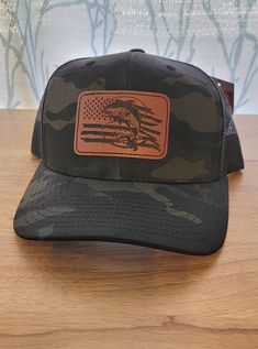 We take pride in creating custom-made-to-order hats with handcrafted leather patches. Our commitment to quality means we only use the finest materials, including top-grade leather that is laser engraved and then sealed for a rich finish. Our patches offer faux stitching and are heat-bonded to the hats. The result is a unique and beautifully finished product that you can be proud to wear. PATCH DETAILS: Leather colors available: Golden Brown, Dark Brown, or Gray Patches are bonded to all hats **not stitched on** If you don't see a hat color or style you want, feel free to message us for availability. How to take care of your leatherette patch hat: leather patches should ONLY be cleaned with water by gently wiping with a damp rag (NOT soaking wet). The hat's inside and outside can be spot cl Adjustable Trucker Hat With Leather Backing And Curved Brim, Adjustable Leather-backed Trucker Hat With Curved Brim, Custom Hat With Leather Patch And Flat Bill, Custom Flat Brim Hats With Leather Patch, Custom Flat Bill Hat With Leather Patch, Adjustable Short Brim Hat With Leather Patch, Trucker Hat With Leather Patch And Short Brim, Country Style Cap With Leather Patch, Leather Hats With Leather Patch