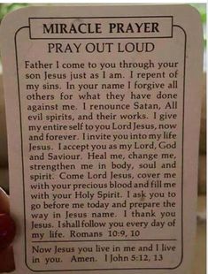 a hand holding up a prayer card with the words,'pray out loud '