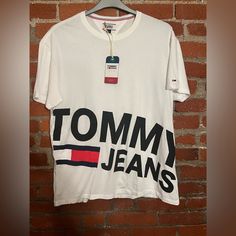 When You Bundle 3+ Items You Receive Discounts And Only Will Pay One Shipping Fee! Most Items Ship Next Day Except Friday-Saturday And Holidays! Please Note Items May Come From Pet Households, All Items Are Clean And Washed But There Still May Be Some Pet Hair Caught In The Fabric! Tommy Hilfiger White Crew Neck Top, Trendy Tommy Hilfiger Cotton T-shirt, Tommy Hilfiger White T-shirt With Graphic Print, Tommy Hilfiger Graphic Tee With Graphic Print, Tommy Hilfiger Graphic Print Tee, Tommy Hilfiger Tops With Letter Print For Summer, White Cotton Tommy Hilfiger T-shirt, Tommy Hilfiger Logo Print T-shirt For Spring, Tommy Hilfiger Tops With Logo Print For Spring