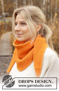 a woman wearing an orange knitted scarf