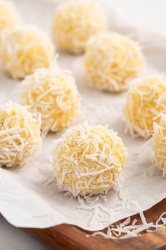 several balls of cheese are on a cutting board