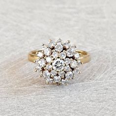 Vintage 1.03 Ctw Diamond Cluster Ring, Floral Design Ring 18K Yellow Gold, Sparkly and Gorgeous! GIA G.G. Appraisal Included 2,490 Usd! A stunning cluster of bright white diamonds, all full round brilliant cut, decorate this crown that measures approximately 13.48mm in diameter and rises 10mm from the finger. The shank is smooth and polished and measures 2mm at the back. Inside the shank is stamped with what is presumed a makers mark of "JF" as well as "18K". This is a wonderful piece for an eng Luxury Gold Cluster Ring With Pave Setting, Vintage Diamond Cluster Rings, Lovely Ring, Fine Jewelry Collection, Diamond Cluster Ring, Diamond Cluster, Vintage Diamond, White Diamonds, Round Brilliant Cut Diamond