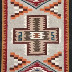 an old navajo rug with geometric designs on it