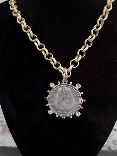 I made this necklace using a reproduction coin that features Queen Elizabeth II. I used a gold colored alloy metal chain that is nickel free. I closed it with a toggle closure. Offered in a variety of lengths. Vintage Metal Medallion Necklace With Coin Pendant, Metal Charm Necklaces With Gold Chain, Vintage Metal Coin Necklace With Round Pendant, Metal Medallion Necklace With Gold Chain, Medallion Necklace With Gold Chain, Vintage Gold-tone Chain Necklace With Coin Pendant, Vintage Coin Shaped Medallion Necklace, Vintage Gold-tone Coin Necklace, Gold Coin Necklace Nickel Free