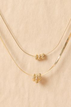 This delicate two-layer necklace features dainty chains that gracefully cascade, adding a touch of elegance to any ensemble. The encrusted gold sliding charms are the perfect addition to elevate this piece. White Dress Boots, Accessories Jewelry Necklace, Altar'd State, Dress With Boots, Layered Necklaces, New Shoes, Sliders, Charm Necklace, Jewelry Necklace Pendant