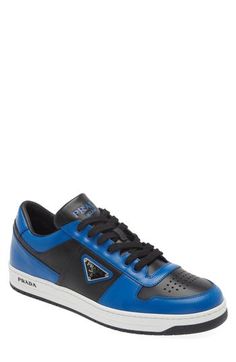 Trims in a bold primary color zip around the silhouette of this low-top leather sneaker featuring a perforated toe and three versions of the iconic Prada logo. Lace-up style Removable insole Leather upper/leather and textile lining/synthetic sole Made in Italy Men's Designer Shoes Blue Leather Sneakers With Logo, Blue Sporty Sneakers With Embossed Logo, Sporty Blue Sneakers With Embossed Logo, Blue Low-top Calf Leather Sneakers, Modern Blue Sneakers With Perforations, Luxury Blue Sneakers With Perforated Toe Box, Prada Logo, Mens Designer Shoes, Sneaker Men