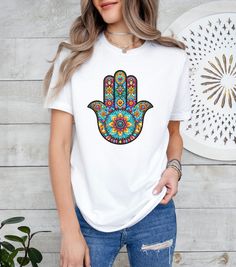 Hamsa Evil Eye Shirt, Boho Mandala Tshirt, Third Eye Shirt, Spiritual Shirt, Witchy Shirt, Witchy Gift, Spiritual Gift, Gift for Sister, Mom Welcome to my store! Our shirts are designed to add joy and color to your life. Feel free to ask me anything you may need help with, I'm happy to assist you in any way. *please note, there may be changes in the color shade depending on the screen on which the item is viewed. --------------------------------------------------------------------------------- B Bohemian Multicolor Crew Neck Shirt, White Bohemian Crew Neck Top, Bohemian White T-shirt With Graphic Print, White Bohemian T-shirt With Graphic Print, White Bohemian Top With Graphic Print, White Bohemian Cotton T-shirt, White Bohemian T-shirt With Letter Print, White Bohemian Top With Screen Print, White Bohemian Shirt With Crew Neck