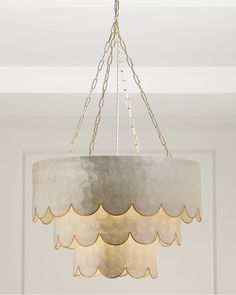 a chandelier hanging from a ceiling in a room with white walls and ceilings