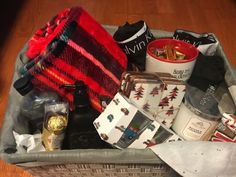 a basket filled with lots of items on top of a wooden floor