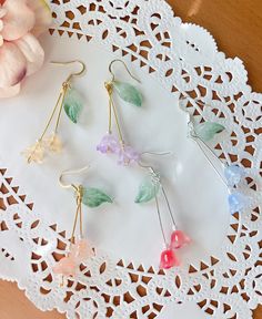 Wisteria earrings These wisteria earrings feature colorful flowers, one green leaf, crystals. Let's keep wisteria blooming! Available in GOLD finish! Also can make in silver. M A T E R I A L S * A N D * S I Z E  The hook is 14k gold filled - Length: 43 mm(without hook) - Width: 12mm Lily of the valley is a symbol of humility and happiness P L E A S E * N O T E No two pieces of jewelries are exactly alike, due to their handmade nature, which makes it more unique! Spring Flower Dangle Earrings Gift, Spring Birth Flower Jewelry, Whimsical Spring Flower Earrings With Ear Wire, Delicate Spring Jewelry Gift, Delicate Spring Jewelry For Gift, Flower-shaped Jewelry With Matching Earrings For Spring, Delicate Dangle Earrings For Spring, Gold Birth Flower Jewelry For Summer, Spring Flower Earrings For Gifts