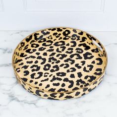 a leopard print tray sitting on top of a marble counter