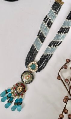 "Gorgeous Blue Gray Beaded Polki Kundan Onyx Layered Mala Necklace. Perfect party wear necklace on any Indian / Indo Western Attire. Premium Quality as always.   WHAT GOES IN  👉🏻Premium Quality Onyx Beads with lustrous Kundan and AD & colored stones.  👉🏻Length adjustable: 26\" approximately We want you to LOVE your new jewelry!  CARE TIP  1. Keep away from moisture and perfume 2. Store in cotton or zip lock bags or air tight boxes.  3. Spot cleaning only.  4. Jewellery is the last thing you should wear and the first thing you should remove.  Send us an email if you need help!  SHIPPING & TURNAROUND  We follow item dispatch in 1-2 business days for most of our shipments. All pre orders will take approximately 3 weeks. We offer Free domestic delivery across US. Most deliveries are done i Sabyasachi Wedding, Pearl Beaded Necklace, Blue Onyx, Grey Beads, Wear Necklaces, Colored Stones, Mala Necklace, Onyx Bead, Indo Western