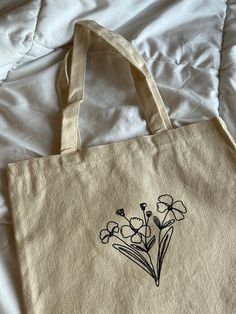 a tote bag with flowers drawn on it