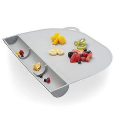 a tray with various fruits and berries on it