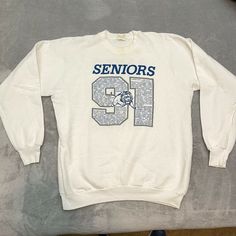 Some staining around the collar. See pics. All offers considered! Seniors Baker Class Of 1991 Lions Sweatshirt White Fruit Of The Loom XL CP Throwback Long Sleeve T-shirt For College, Throwback Long Sleeve Letter Print T-shirt, College Throwback Style Sweatshirt With Screen Print, White Throwback Sweatshirt With Letter Print, White Throwback Sweatshirt With Graphic Print, Throwback White Sweatshirt For Sports Season, White Throwback College Sweatshirt, Vintage Oversized Tops With Lettering, Vintage Oversized Top With Lettering