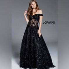 Make A Statement At Your Next Formal Event In This Breathtaking Jovani Gown. This Show-Stopping Black Dress Exudes Glamour And Sophistication With Its Intricate Design And Alluring Silhouette. The Bodice Features A Daring Off-The-Shoulder Neckline, Accentuating The Dcolletage With Elegance. A Stunning Sheer Corset-Style Midsection Adorned With Delicate Embroidery And Sequins Creates A Captivating Focal Point, Offering A Tasteful Glimpse Of Skin While Maintaining An Air Of Mystery. The Gown's Ful Black Evening Gown With Sweetheart Neckline, Black Sweetheart Neckline Evening Gown, Black Gown With Sweetheart Neckline For Evening, Black Gala Gown With Sweetheart Neckline, Black Gown With Sweetheart Neckline For Gala, Black Floor-length Gown For Gala, Glamorous Black Gown With Sweetheart Neckline, Black Gown With Fitted Bodice For Evening, Glamorous Black Gala Gown