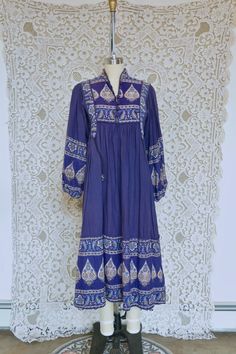 This dress is made from soft thicker indian cotton in rich indigo blue Indian tapestry print! The cut of this piece is amazing, it features a sweeping tent silhouette, long sleeves and POCKETS! This piece is laid back and easy but also full of bohemian glamour. It is marked size 38 but would best fit a small, see measurements for details. All measurements taken flat across. Measurements Shoulder: 16" Bust: 18" Sleeve: 24" Hip: 32" Length: 46" Indigo Long Sleeve Cotton Dress, Long Sleeve Indigo Cotton Dress, Indigo Long Sleeve Dress For Fall, Indigo Bohemian Dress With Batik Print, Bohemian Indigo Batik Print Dress, Long Sleeve Batik Print Festival Dress, Tent Silhouette, Bohemian Glamour, Tapestry Print