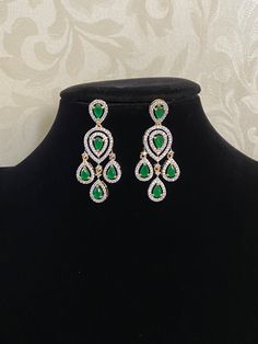 Perfect fusion of tradition and luxury Earrings Unique design at amazing ideal earrings Light weight AD Maang tikka Elegant Green Chandelier Earrings For Diwali, Green Danglers For Reception, Green Earrings For Reception And Festive Occasions, Green Latkans Earrings For Reception, Diwali Reception Chandelier Drop Earrings, Diwali Reception Drop Chandelier Earrings, Green Drop Earrings For Diwali, Green Drop Earrings For Bridal Diwali, Green Drop Bridal Earrings For Diwali