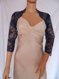 This is a beautiful, delicate, hand made dark blue lace shrug ideal for weddings or special occasions. It can be worn to dress up casual clothes as well. The lace edging provides an attractive edge to the shrug and its sleeves. It can be made in any size from 8 to 24 (UK sizes). It is made in the UK. (For larger sizes please see my separate listing). It is normally sent out to you within 5 days, but I am very happy to make your order a priority if you need it urgently. Just let me know the date Elegant Blue Lace Top, Fitted Lace For Mother Of The Bride, Elegant Blue Lace Top With Lace Trim, Fitted Blue Lace Top With Lace Trim, Blue Fitted Lace Top For Party, Fitted Lace Shrug With Lace Trim, Fitted Lace Trim Party Shrug, Elegant Fitted Lace For Wedding Night, Fitted Lace Trim Shrug For Party