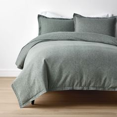 a bed with two pillows on top of it and a pillow case in the middle