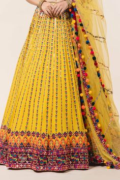 Yellow lehenga with attached cancan, all-over multicolored applique work, sequin embellishments and drawstring with tassels. Comes with sweetheart neckline padded blouse and tulle dupatta.
Component: 3
Embroidered
Neckline: Sweetheart
Sleeve Length: Sleeveless
Fabric: Lehenga and Blouse: Georgette; Dupatta: Tulle 
Color: Yellow
Applique, resham, sequin and patra embroidery
Embroidered blouse with cutwork and pompoms at the hem
Tie-up at the back with pompoms
Embroidered dupatta - Aza Fashions Multicolor Mirror Work Sharara For Wedding, Wedding Multicolor Georgette Palazzo Set, Bohemian Saree-style Wedding Gown, Bohemian Wedding Gown With Resham Embroidery, Bohemian Wedding Dress With Motifs, Yellow Anarkali Set With Mirror Work For Reception, Bollywood Style Floor-length Sets With Motifs, Bollywood Floor-length Sets With Motifs, Saree Dress With Motifs For Reception