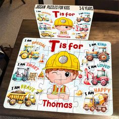 two children's jigsaw puzzles on a table with construction themed artwork