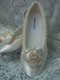 READY TO SHIP SHOES USA SIZE: 6, AS SHOWN IN PICTURE. READY TO SHIP SHOES USA SIZE: 8, AS SHOWN IN PICTURE. *If you need a different color or size please see below. COLOR: IVORY Description: Fancy Flower 1.5'' X 1.5'' pearl edging, unique pearls edging trim on shoe. Gorgeous Ivory Satin Flower Rosette with Pearls along the edges. So exquisite and unique. Perfect for after a long day of heels. These flats are satin, with man-made insoles, and sueded leather outer soles. (Please Note: These are NO Ivory High Heels, Ivory Flats, Lace Garter Set, Pearl Bracelet Wedding, Great Gatsby Fashion, Ivory Shoes, Ballet Style, Satin Hands, Ballerina Slippers