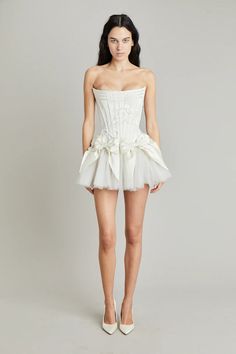 Elevate your style with the Tiara Mini Dress! Crafted with luxurious off-white silk double-faced satin, this dress features a playful mini bow skirt and a delicate corset. Complete your look with the tulle tutu for a touch of elegance and charm. Perfect for any occasion, make a statement with this must-have dress! Satin Mini Skirt, Bow Skirt, Looks Party, Dream Wedding Ideas Dresses, Mini Robes, Mode Ootd, Reception Dress, Glam Dresses, Wedding Dress Inspiration