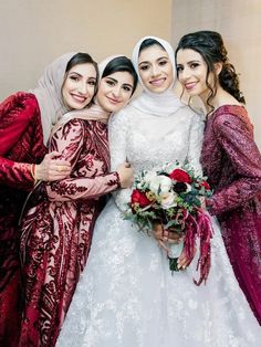 three women dressed in red and white are posing for the camera with one woman holding a bouquet