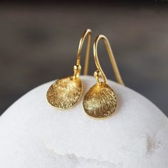 Gorgeous, curved teardrops of gold vermeil feature a shiny, brushed finish and hang from simple gold vermeil ear wires. These earrings glint and sparkle with your movements and work equally well for everyday or special occasions. The teardrops measure 14mm long and the entire earring measures just under one inch from the top of the ear wire to the bottom of the drop. Feminine Closet, Gold Teardrop Earrings, Earrings Everyday, Sparkle Earrings, Brushed Metal, Metal Earrings, Ear Wire, Wedding Earrings, Teardrop Earrings