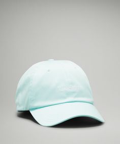 a mint green hat with the word's on it, sitting against a gray background