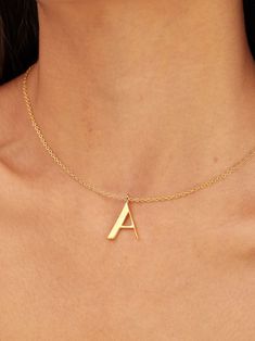 Light in weight but heavy in meaning, our Signature Initial Necklace does more than spell a name. This initial collection is a celebration of people, places, and things that represent you -- creating a deeply meaningful and bespoke piece that is a great go-to piece for every day. Medium in size, the letter pendant is 24K gold-plated and threads through a delicate gold-plated chain. Available in letters A through Z. Dimensions: Sheet Thickness: 0.08in (2mm)Wire Thickness: 0.04in (0.9mm)Overall he Symbolic Gold Initial Pendant Jewelry, Recycled Gold Initial Pendant Necklace Gift, Gift Initial Pendant Necklace In Recycled Gold, Gift Recycled Gold Initial Pendant Necklace, Gold Symbolic Jewelry With Initials, Modern Gold Necklace With Initials, Modern Gold Initial Pendant Necklace, Modern Initials Pendant Jewelry, Personalized Gold Necklaces In Recycled Gold