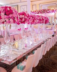 a long table is set up with pink flowers