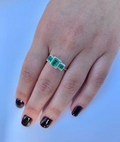 "Pacific Jewelry Presents, 3 Emerald cut natural Colombian Emeralds paired together in a vintage 18k white gold setting and adorned with 0.19 carats of round cut diamonds. ✔ Gold Karat: 18K ✔ 3 Emeralds: 1.03 carat total weight ✔ Round Diamond: 44 pieces, 1 MM, 0.19 carats ✔ Zero degree of clarity enhancement ✔ Emerald origin: Muzo mine, Colombia ✔ Ring Size: 7 1/2 U.S. SHIPPING TIMES USA: 4-12 business days (USPS) Canada: 5-14 business days Australia: 5-12 business days (Australia Line) New Zea Elegant Three-stone Emerald Diamond Ring, Elegant Three Stone Emerald Diamond Ring, Fine Jewelry 14k White Gold Three Stone Ring, 14k White Gold Three Stone Ring Fine Jewelry, 14k White Gold Three-stone Jewelry, 14k White Gold Three Stone Jewelry, 14k White Gold Three Stone Ring, Elegant Three Stone Emerald Ring In White Gold, White Gold Emerald Diamond Ring With Three Stones